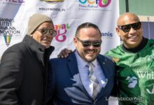 he Kiwanis Club of Little Havana's president, Pablo Lau (C) poses with the members of the Cuban reggaeton duo Gente de Zona