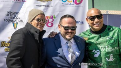he Kiwanis Club of Little Havana's president, Pablo Lau (C) poses with the members of the Cuban reggaeton duo Gente de Zona