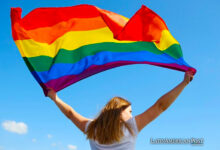 Woman holding a rainbow flag
