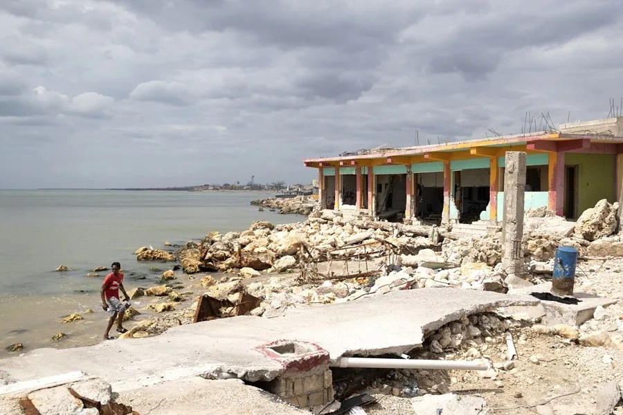 A person walks through an area damaged by Hurricane Melissa near the port of Black River, Jamaica, on November 12, 2025. EFE/Orlando Barría